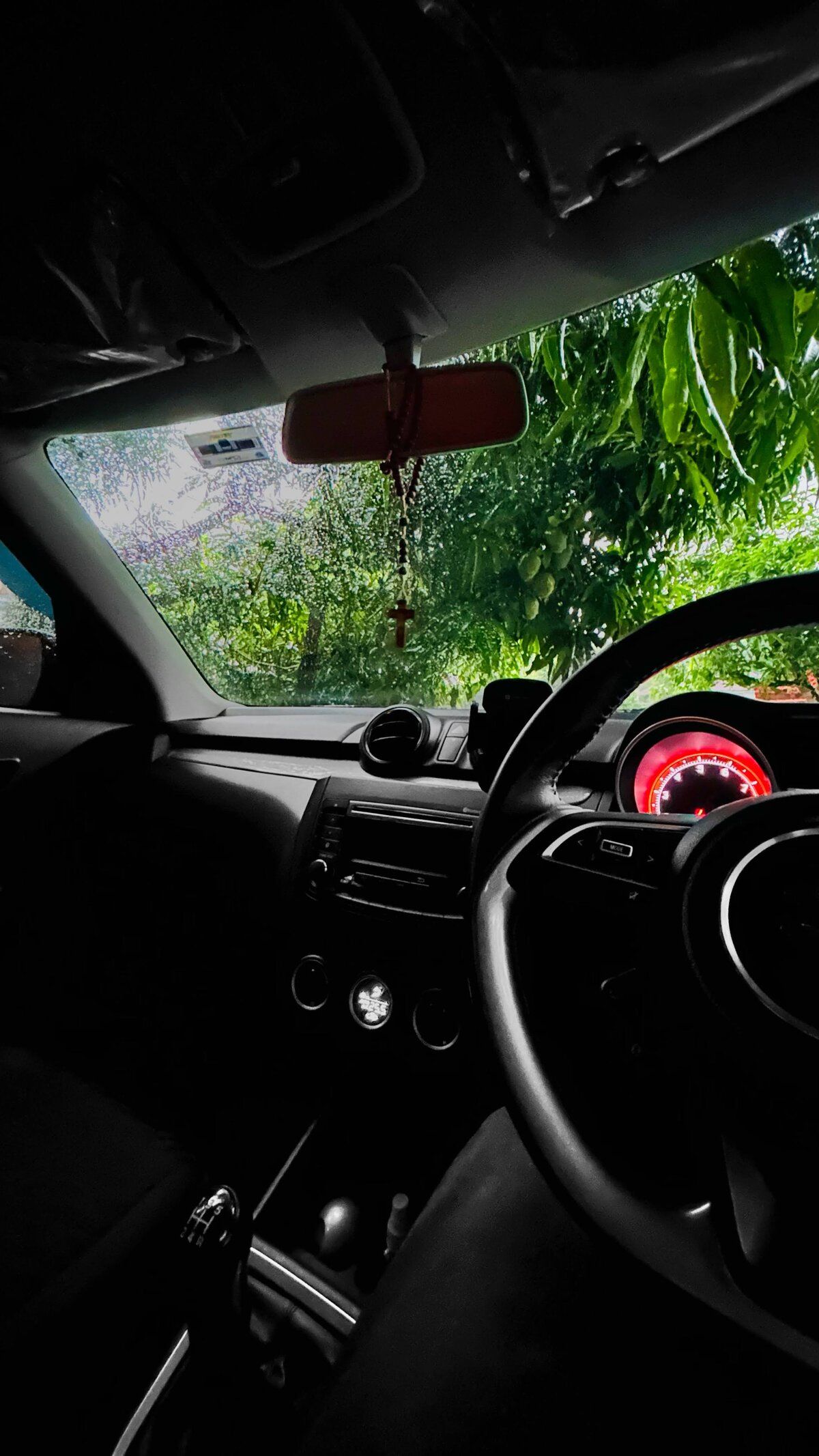 Car in a greeny place on a rainy day