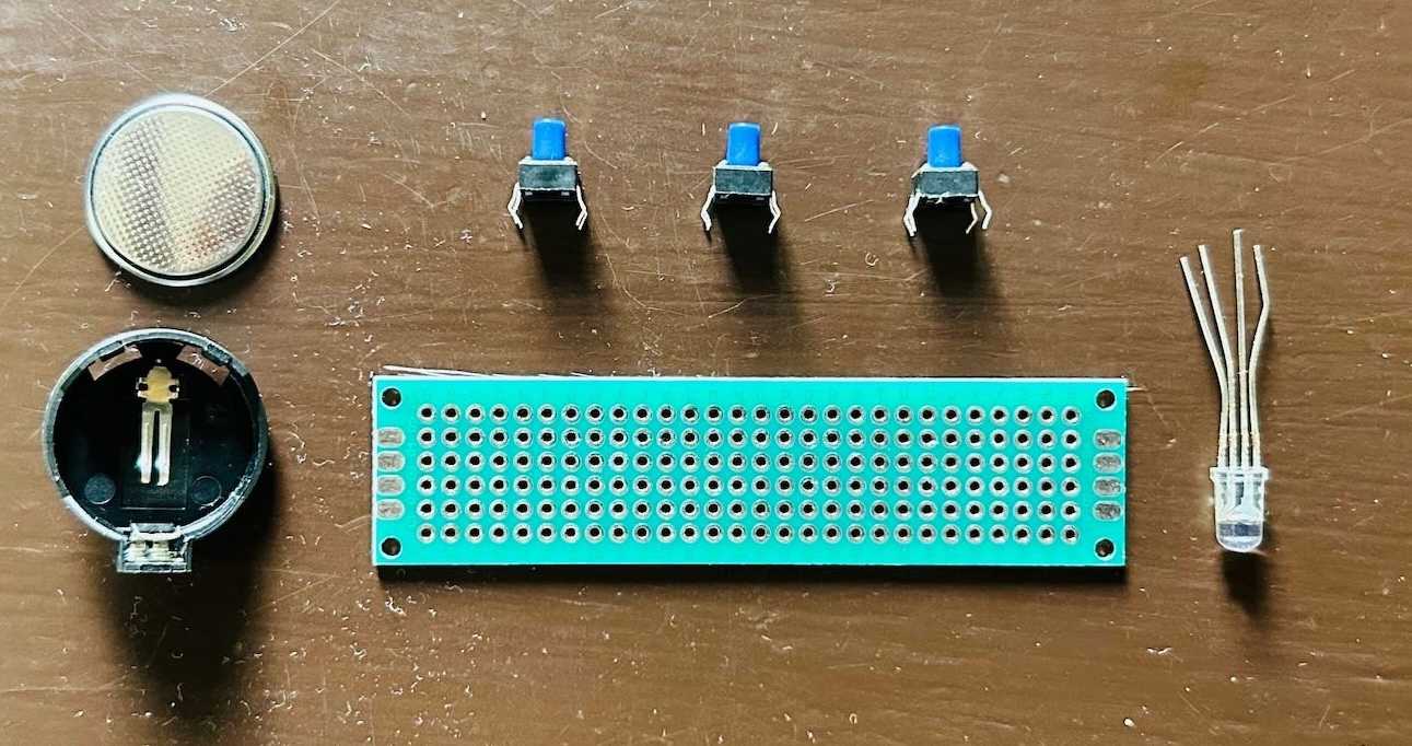 Circuit components - RGB LED, push buttons, CR2032 battery, and resistor